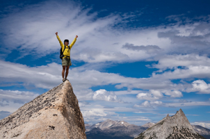Rock climber celebrates on reaching summit